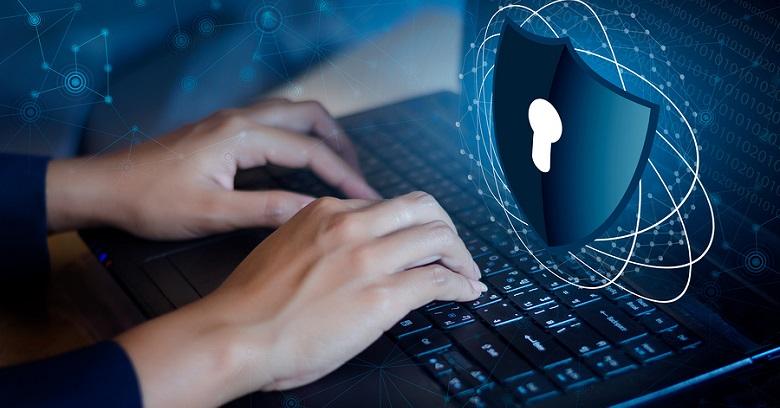 Hands typing on a laptop keyboard with a digital padlock and shield graphic overlay, representing cybersecurity or data protection.