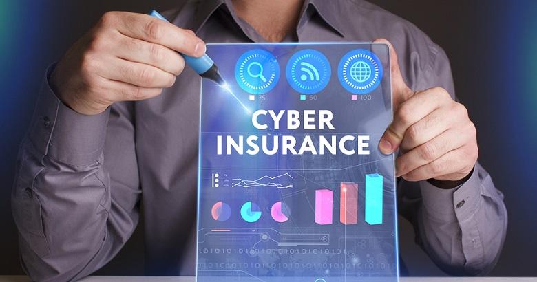 Person holding a transparent digital tablet displaying the words Cyber Insurance with various charts and icons related to technology and data.