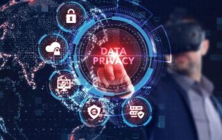A person wearing VR goggles points at a virtual interface displaying the words Data Privacy with security icons and a digital world map in the background.
