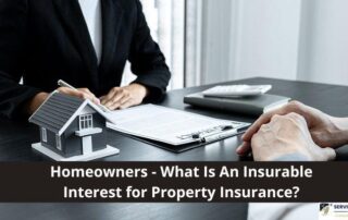Two people sit at a desk with documents, a model house, and a calculator; the text asks about insurable interest for property insurance.