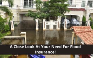Flooded residential street in front of a gated house, with water covering the driveway and entrance, highlighting flood insurance necessity.