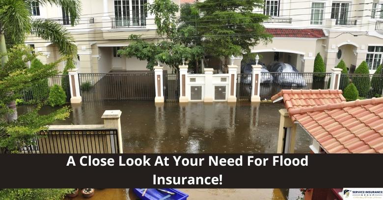 Flooded residential street in front of a gated house, with water covering the driveway and entrance, highlighting flood insurance necessity.