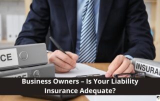 A person in a business suit sits at a desk with files labeled Insurance, writing on a document. Text reads: Business Owners – Is Your Liability Insurance Adequate?.