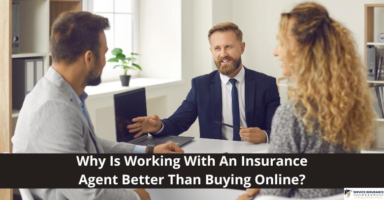 Three people sit at a desk in an office setting, with one man in a suit speaking to a man and a woman. Text reads: Why Is Working With An Insurance Agent Better Than Buying Online?.