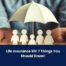 Paper cutout figures of a family are sheltered under a white umbrella, with text reading Life Insurance 101: 7 Things You Should Know! at the bottom.